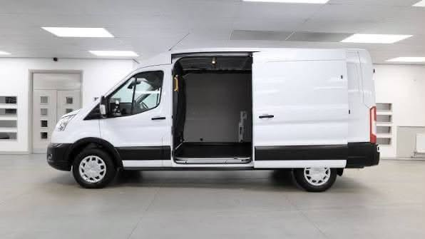 Side view of the van with the sliding door open, showing a bare, unfitted interior.